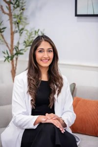 Medium shot of Dr. Pinky Vanmali smiling while sitting in her office.